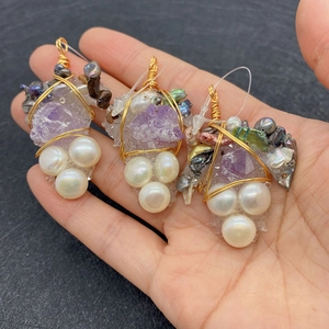 Detailed view of handmade wire-wrapped grape shape amethyst pendants with white pearls