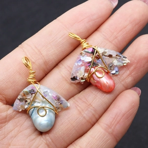 Handmade wire-wrapped freshwater pearl and resin pendants in blue and coral colors