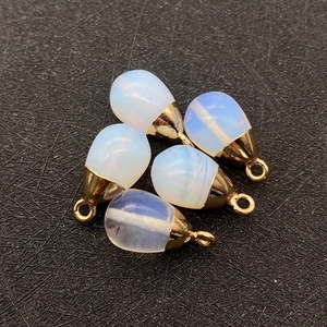 Close-up of teardrop opal style pendants with gold metal bails for DIY jewelry making