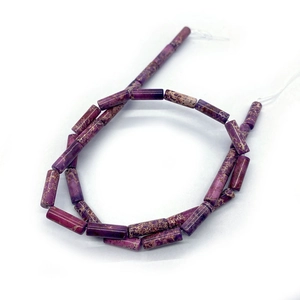 Detailed view of cylindrical purple Emperor stone beads with natural brown vein textures
