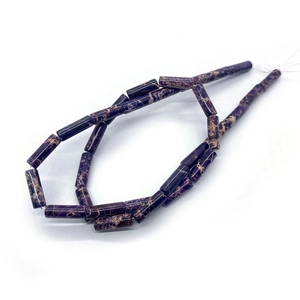 Macro view of purple Imperial Jasper cylinder beads with natural yellow veining texture
