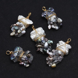 Macro detail of five handmade baroque pearl pendants with gold wire wrapping for DIY jewelry