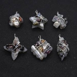 Detailed view of six handmade wire-wrapped pendants with natural pearls and star shapes