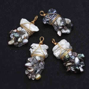 Detail of four handmade baroque pearl pendants with wire-wrapped semi-precious stones