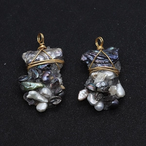 Detail view of handmade wire-wrapped baroque pearl pendants with colorful stones