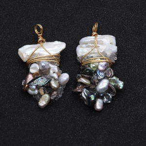 Detail view of handmade baroque pearl pendant with colorful stones and gold wire wrap