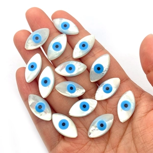 Natural oval sea shell evil eye beads in hand for DIY jewelry making and necklace crafts