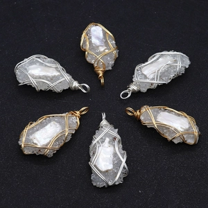 Irregular natural pearl wire-wrapped pendant set with gold and silver handmade metal coils