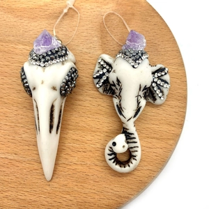 Artistic white acrylic elephant head and bird skull pendants with purple crystal stones