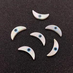Makro-Detail von natürlichen Muschel-Halbmondperlen mit blauem Auge für DIY-Schmuck