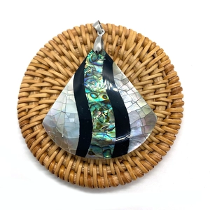 Macro shot of fan-shaped abalone and white mother of pearl inlay shell pendant