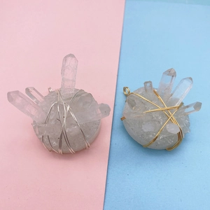 Detailed view of raw white crystal cluster pendants with gold and silver wire wrapping