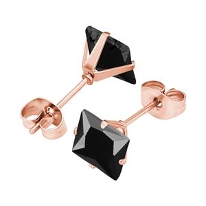 Détails macro de boucles d'oreilles en or rose avec zircons noirs carrés polis