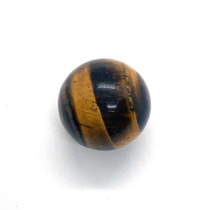 Macro detail of a spherical Tiger Eye stone bead with polished golden-brown texture