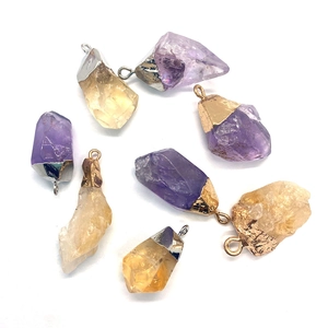 Set of irregular natural quartz pendants in purple and yellow with metal caps and bails