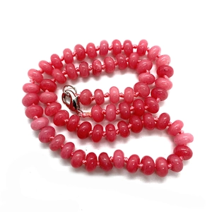 Close-up of pink natural stone abacus beads with polished texture and silver lobster clasp