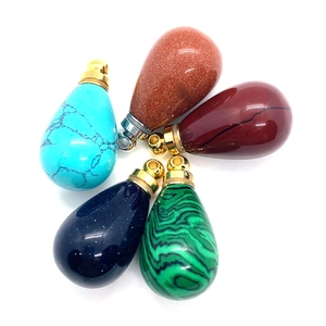 Set of five teardrop natural stone pendants with metal bails on a clean white background