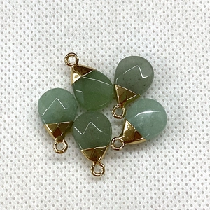 Detailed view of five teardrop-shaped green stones with elegant gold metal clasps