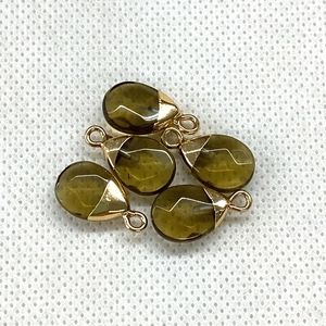 Detail view of five teardrop natural stone pendants with gold caps for DIY jewelry