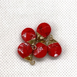 Detail of five faceted red turquoise water drop pendants with gold plated caps for DIY jewelry