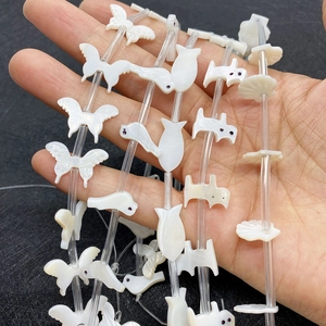 Natural white mother of pearl beads in butterfly and animal shapes with iridescent luster
