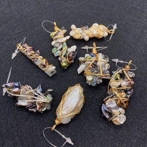 Detail of seven handcrafted irregular pearl and wire-wrapped gemstone pendants