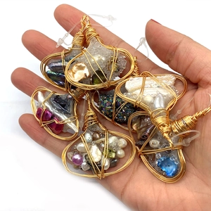 Detail of handmade wire-wrapped pendants with natural stones and baroque pearls