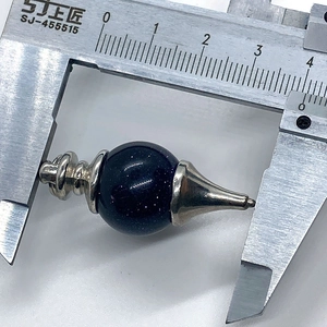 Macro photo of Blue Sandstone pendulum pendant with silver metal caps measured by caliper