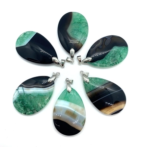 Detailed view of six teardrop agate pendants showing unique natural green and black textures