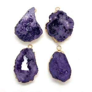 Set of four natural purple crystal pendants with golden electroplated irregular edges