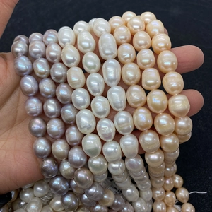 Macro shot of natural AA grade freshwater pearls in white and lavender with baroque texture