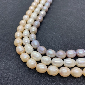 Three-strand natural freshwater pearl necklace in white, pink, and purple shades