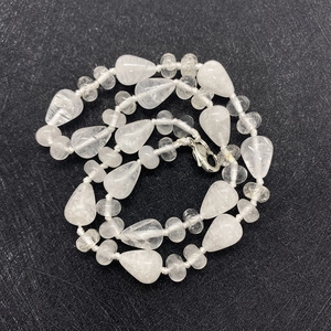 Detail of water drop shaped natural stone beads with silver metal lobster clasp necklace