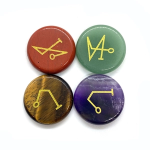Polished gemstone set of amethyst and tiger eye with golden engraved mystical sigils