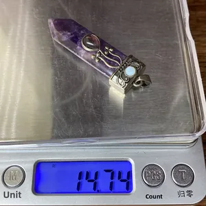 Macro shot of natural amethyst sword pendant weighing 14.74g on a digital scale