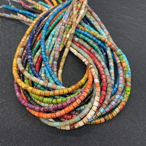 Macro shot of colorful cylindrical emperor stone beads with unique marble patterns