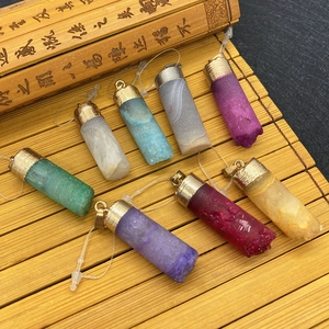 Set of nine faceted hexagonal crystal pendants in various colors with golden caps