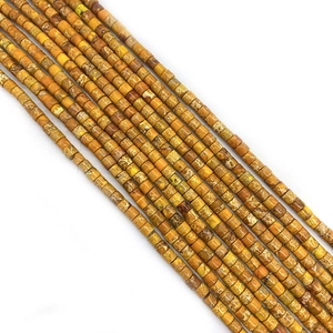 Macro shot of cylindrical emperor stone beads with natural yellow marble texture