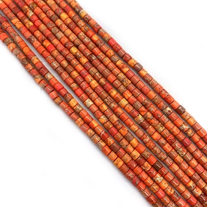 Macro detail of cylindrical imperial jasper stone beads with natural orange textures