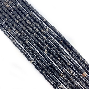 Macro detail of cylinder imperial stone beads with natural black and white marble patterns