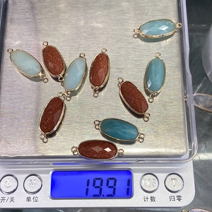 Macro detail of faceted gemstone connectors with gold-plated bezel for DIY jewelry making