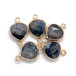 Macro view of faceted natural stone connectors with gold plated borders for DIY jewelry