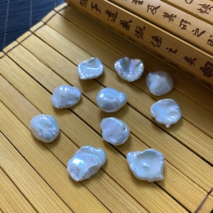 Irregular large white freshwater baroque pearls set on a natural bamboo mat for DIY jewelry