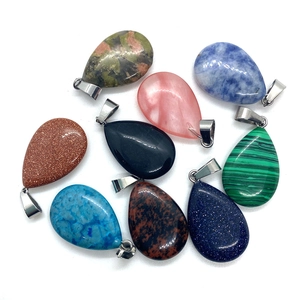 Close-up of teardrop-shaped natural stones and resin pendants with silver metal clasps