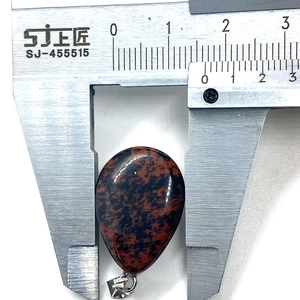 Macro view of teardrop mahogany obsidian stone pendant measuring 20mm with silver clasp