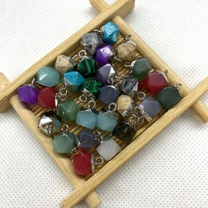 Macro detail of faceted colorful natural stone pendants with silver metal loops