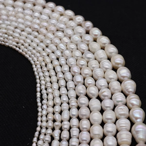 Natural freshwater pearl strands in multiple sizes on black background for jewelry making