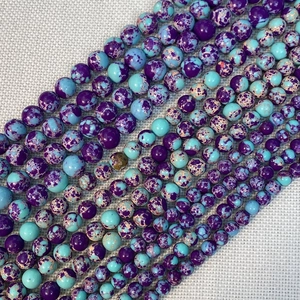 Detail showing blue and purple emperor stone beads in various sizes for DIY jewelry