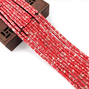 Macro shot of 2x4mm red marble-patterned cylinder stone beads for DIY jewelry making