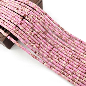 Macro detail of 2x4mm cylindrical pink turquoise stone beads for DIY jewelry making